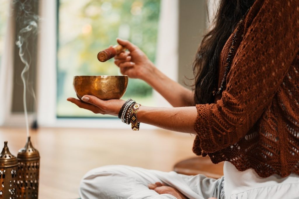 woman holding a bowl of incense