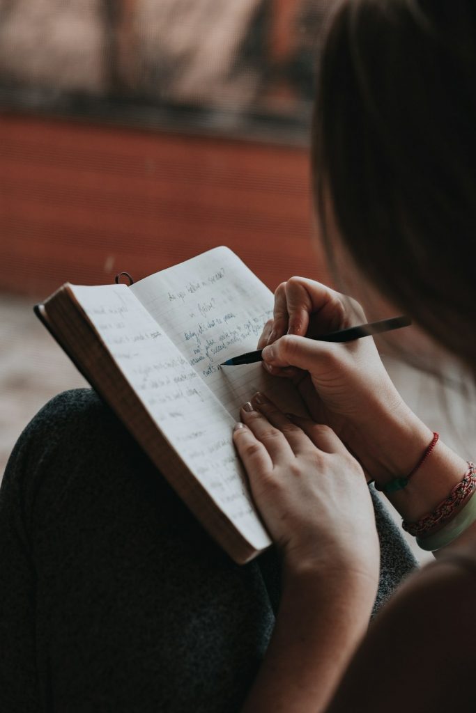 a woman writing in a journal