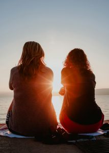 two women sitting side by side